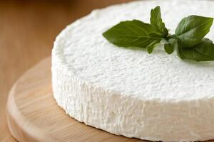 A white cake with a green leaf on top photo