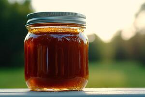A jar of honey sitting on a table photo