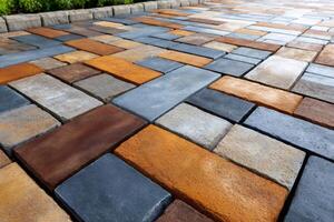 Multicolored cobblestone pavement creating beautiful geometric patterns photo