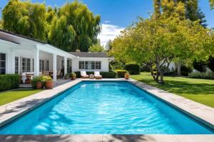 Inviting rectangular swimming pool enhancing a luxurious white house photo