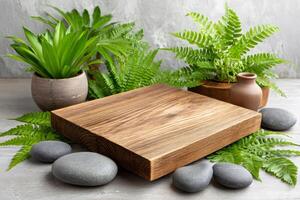 Empty wooden board displaying with green plants and stones on concrete background photo