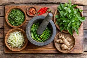 Fresh vietnamese herbs, spices, and ingredients preparing on rustic wooden table photo