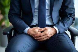 Businessman sitting on chair clasping hands, confidence and authority in corporate setting photo