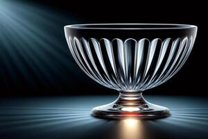 Empty crystal bowl shining under spotlights on dark background photo