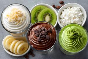 Delicious assorted parfaits with chocolate, banana, kiwi and matcha tea flavoring, creating a delightful dessert spread photo
