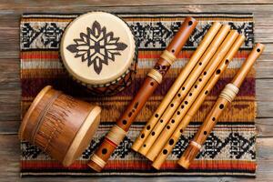 Andean instruments displaying indigenous craftsmanship on wooden table photo