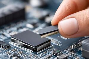 Technician placing microchip on circuit board, installing electronic component photo