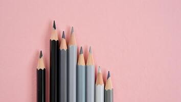 Gray-Toned Pencil Stack on Left with Blush Pink Background photo