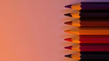 Sunset Palette Pencil Stack on Right Edge with Coral Background photo