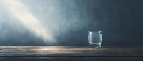 Glass of water on a wooden table with light rays photo