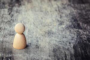 Simple wooden figure on textured surface photo