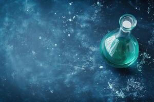 Green glass flask on dark background with texture photo