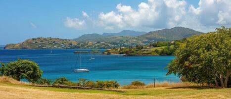 Beautiful coastal view with sailboat on calm water photo