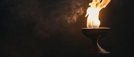 Flame dances in a traditional vessel photo
