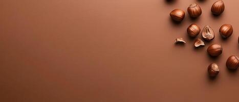 Hazelnuts scattered on a smooth brown surface photo