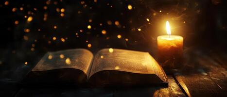 Candlelit reading with an open book on a table photo