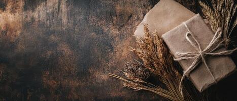 Gift wrapped in brown paper and tied with twine on a wooden background photo