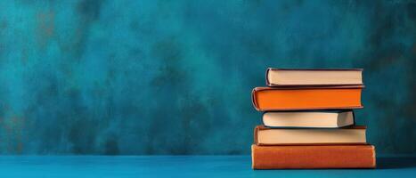 Stack of books on blue background photo