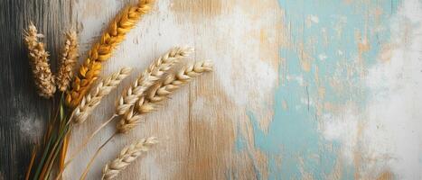 Wheat ears on a wooden background photo