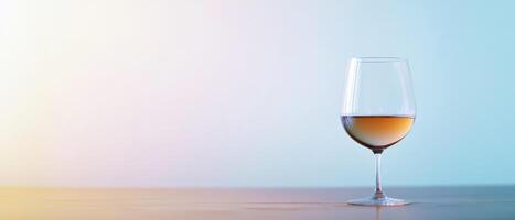 A glass of wine on a table with a blurred background photo