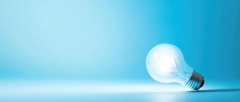Fragile light bulb on blue backdrop photo