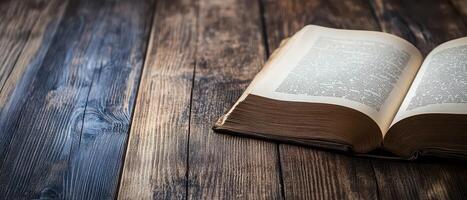 Open book resting on a wooden table surface photo