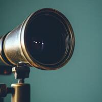 Old telescope displayed against a green wall photo