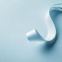 Light blue ribbon curling on a soft surface photo
