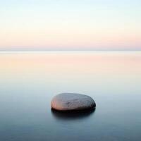 Calm waters reflect soft hues at dawn photo