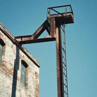 Rusty industrial structure against clear blue sky photo