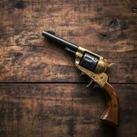 Vintage revolver on rustic wood photo