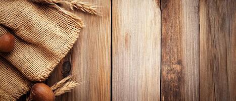 Rustic wooden background with burlap and grains photo