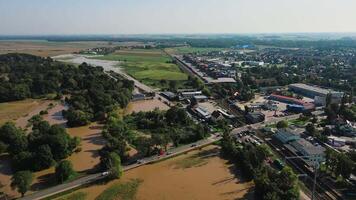Flooded suburban and industrial zone after heavy rain. Concept of infrastructure damage, extreme weather, climate risk and water overflow in rural area video