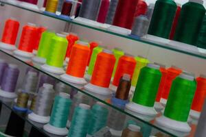Colored embroidery spools with thread photo