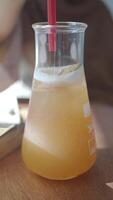 Close-Up of Refreshing Drink Served in a Glass Beaker on a Wooden Table video