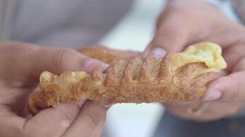 Enjoying a warm pastry in a sunny outdoor setting video