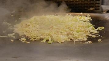 Grilling shredded cabbage in a busy kitchen video