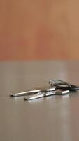 Keys resting on a wooden table in an indoor setting video