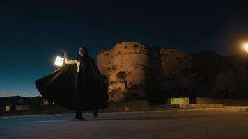 Woman With Cloak And Lantern Spins In A Circle Pirouette At Night Near photo