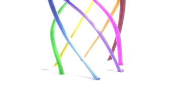 A rainbow colored cord is shown on a white surface video
