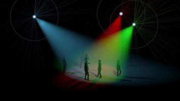 A group of people standing in front of a stage with colorful lights video