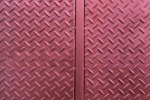 A close up of a red metal door with a diamond pattern photo