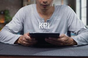 Man Evaluating Key Performance Indicators on a Tablet Display photo