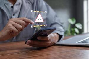 User Monitoring CO2 Levels with Smartphone in Modern Workspace photo