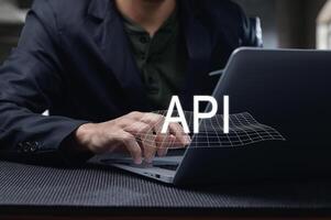 Man Using Laptop to Develop Programming Interface with API Concept photo