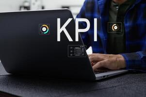 Analyzing Key Performance Indicators on a Laptop in Modern Office photo