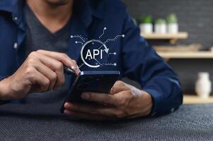 User Interacting with Smartphone Showing API Programming Interface Concept photo