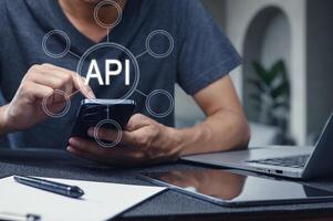 Man Using Smartphone with API Interface Concept Overlaid photo