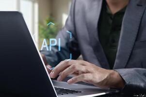 Hands Typing on Laptop with API Concept in Focused Workspace photo