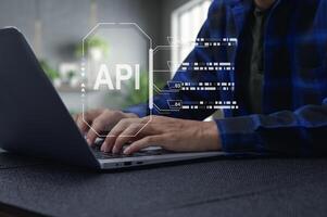 Business Person Working on Laptop with API Interface Visualization photo